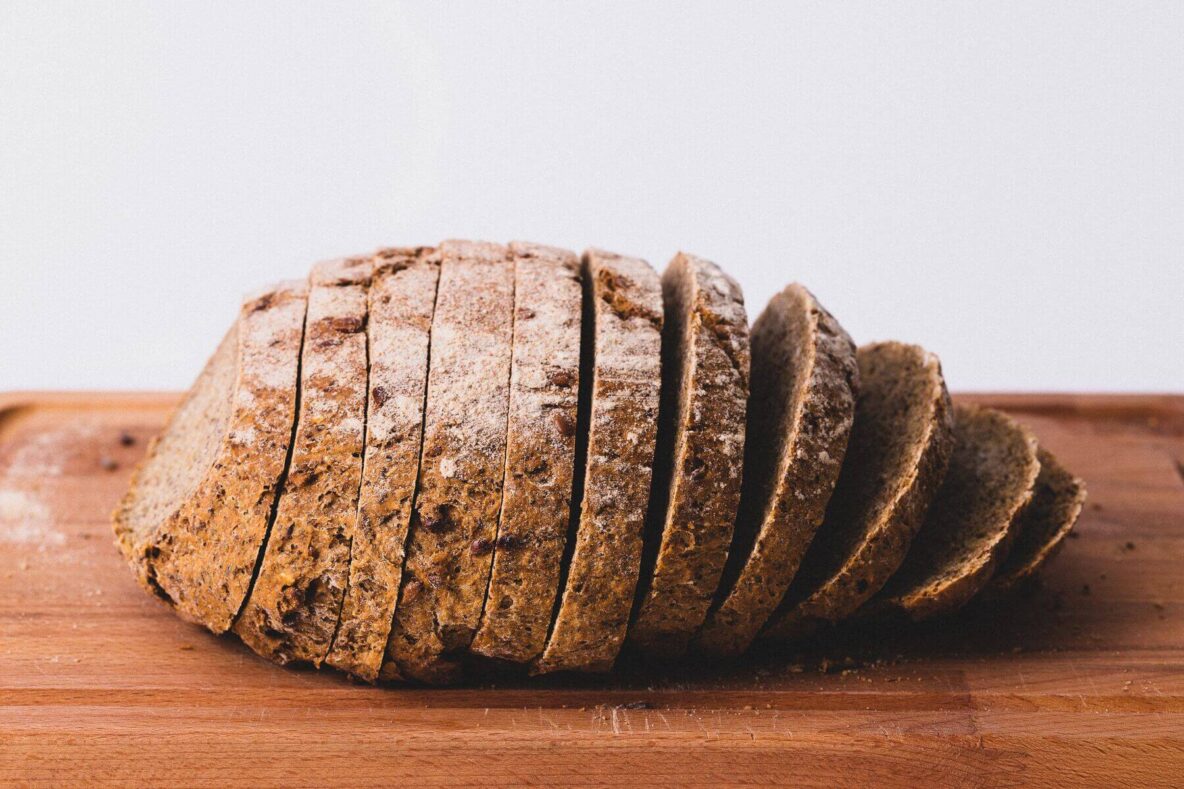 A loaf of fresh bread sitting on a cutting board.