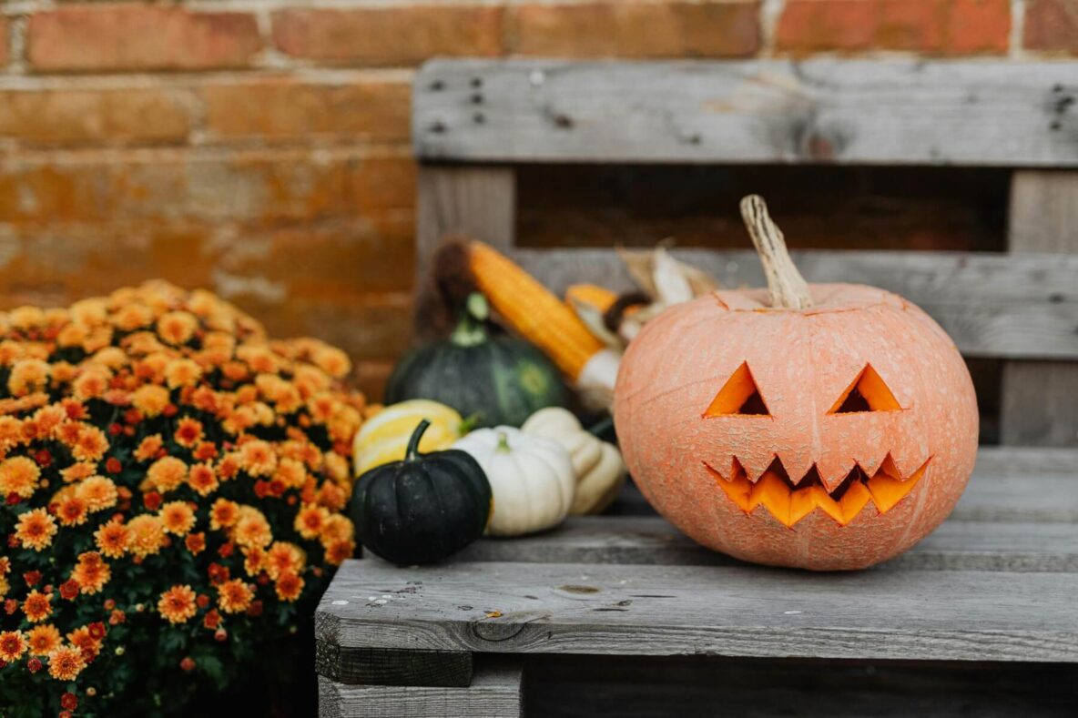 A jack-o-lantern on a front step of a house