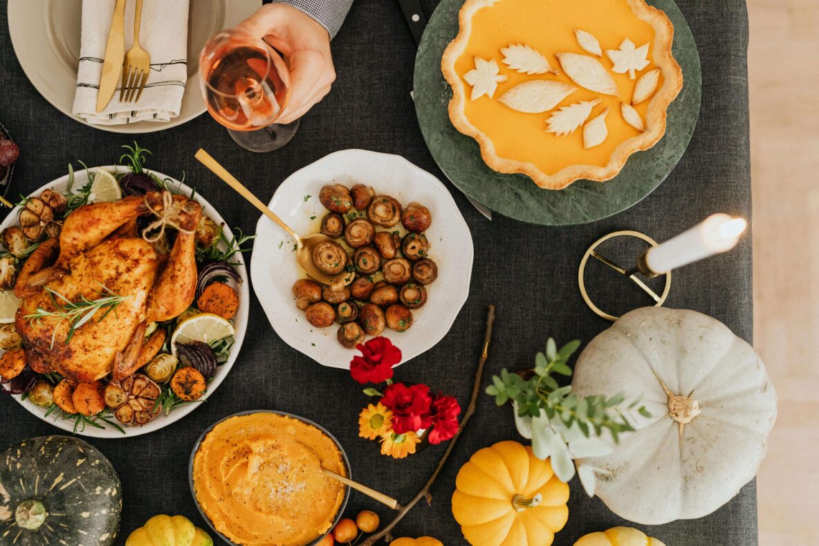 Thanksgiving food spread out on a table with decor.