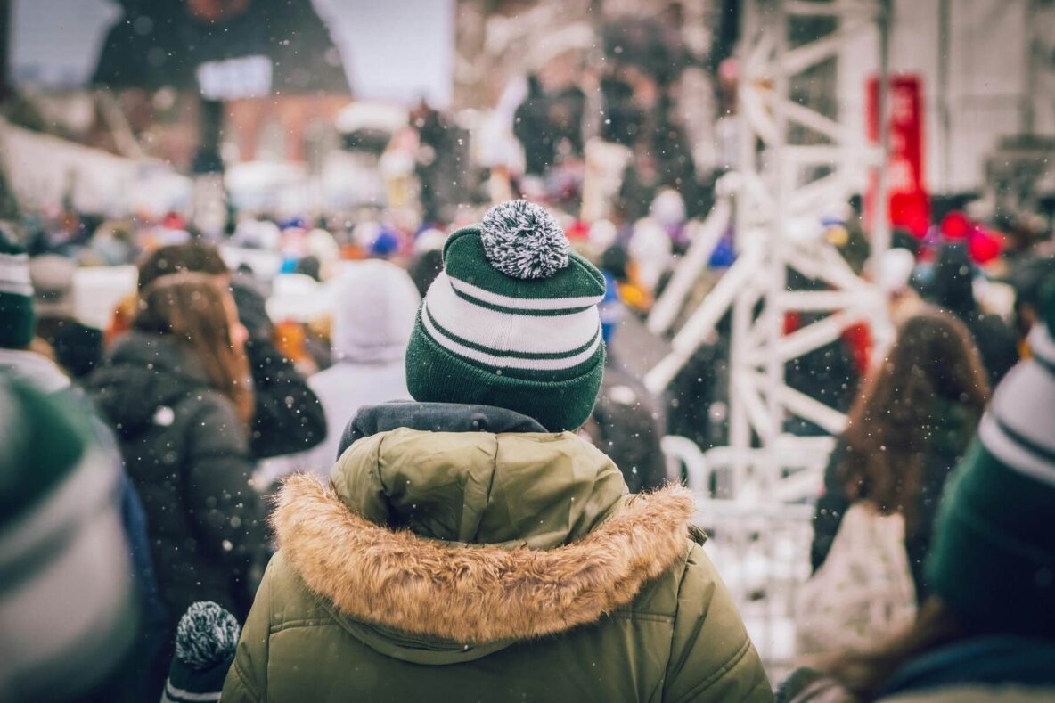 A person walking down the street on a snowy day.