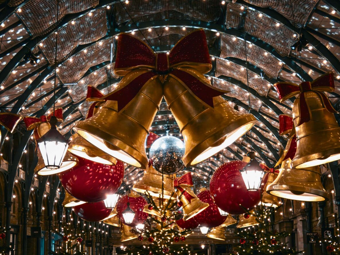 Outdoor area decorated with Christmas bells and lights.